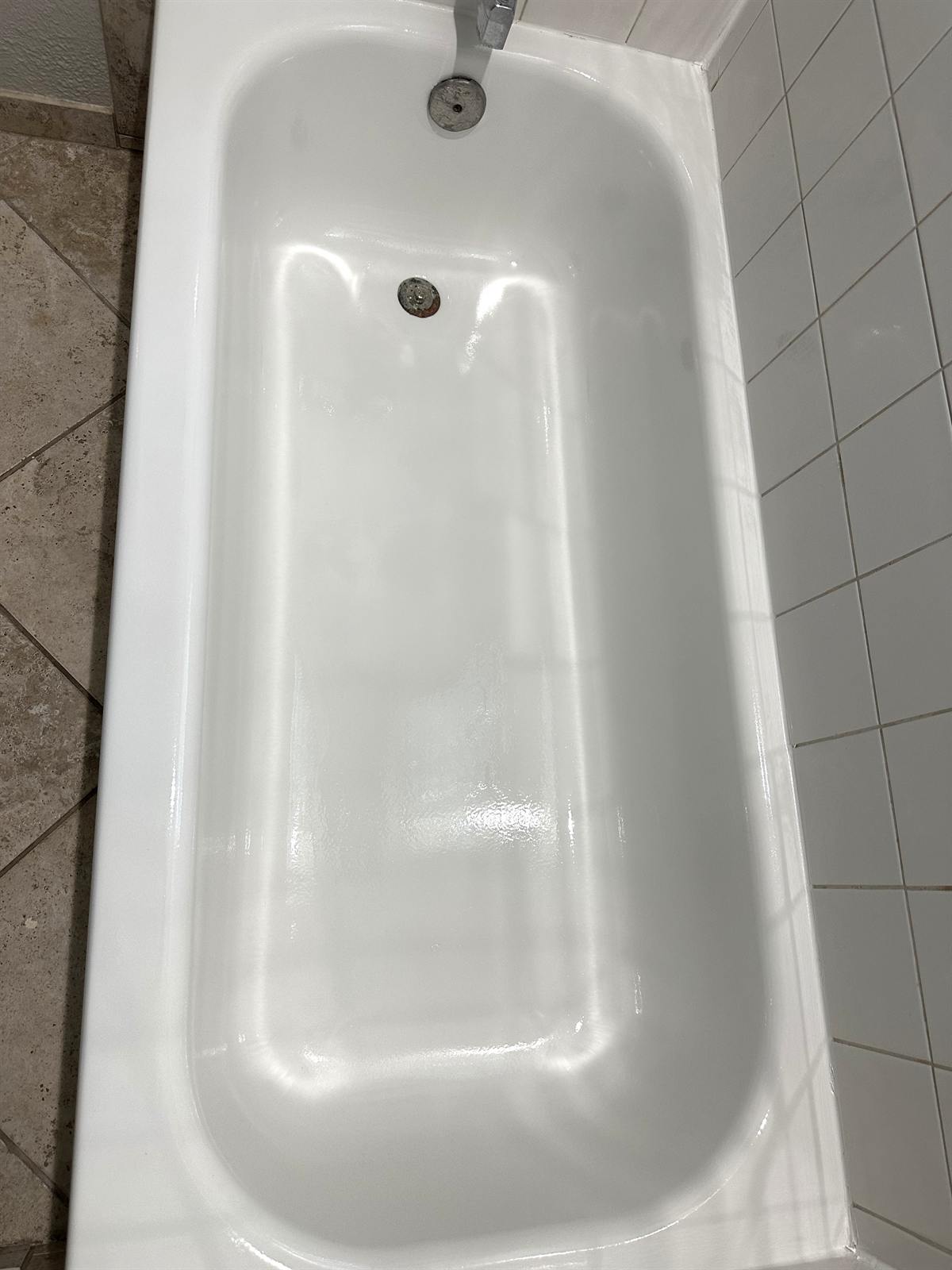 After bathtub refinishing service with bright white restored tub surface