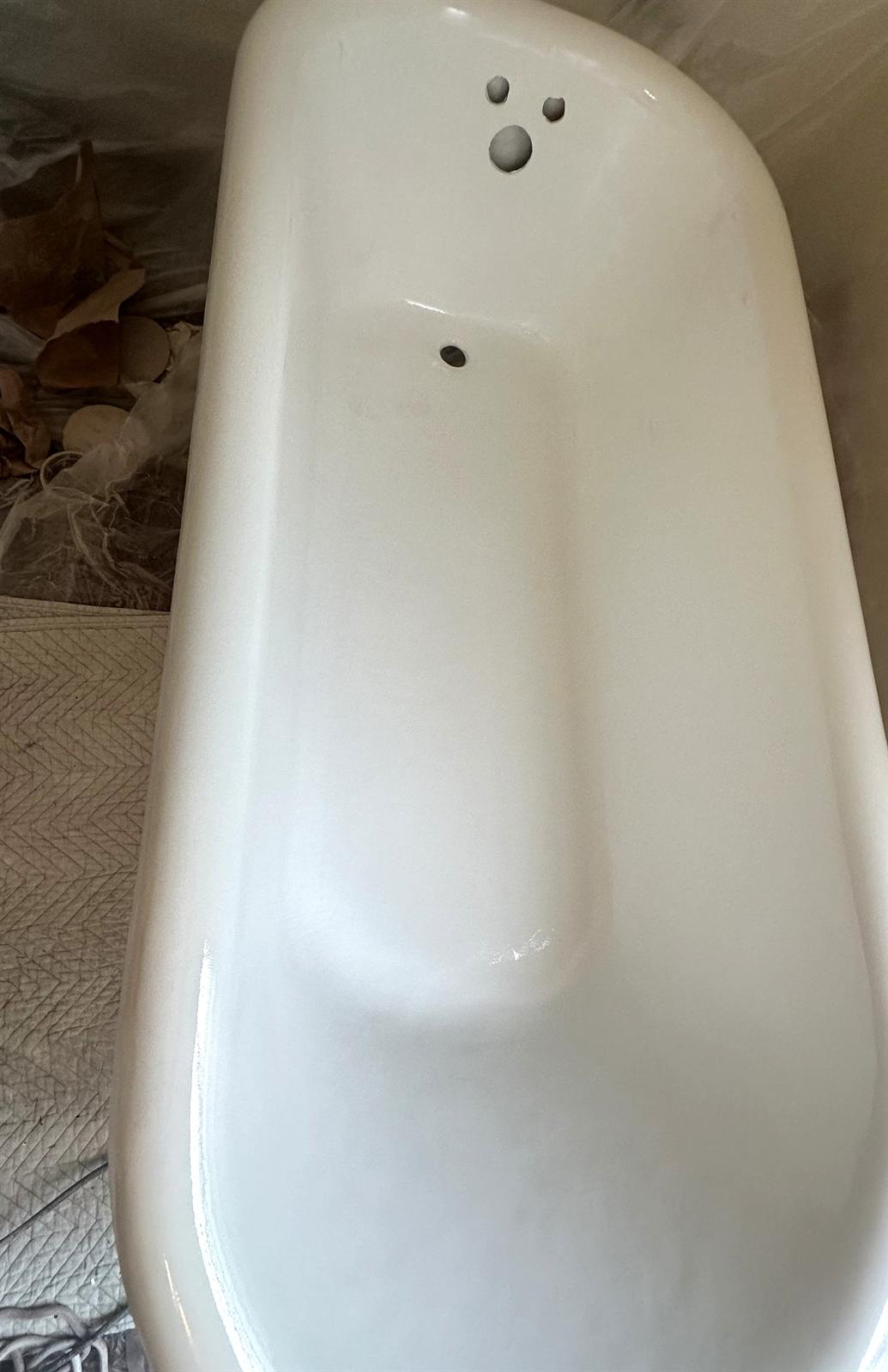 After clawfoot bathtub refinishing with clean aligned white finish