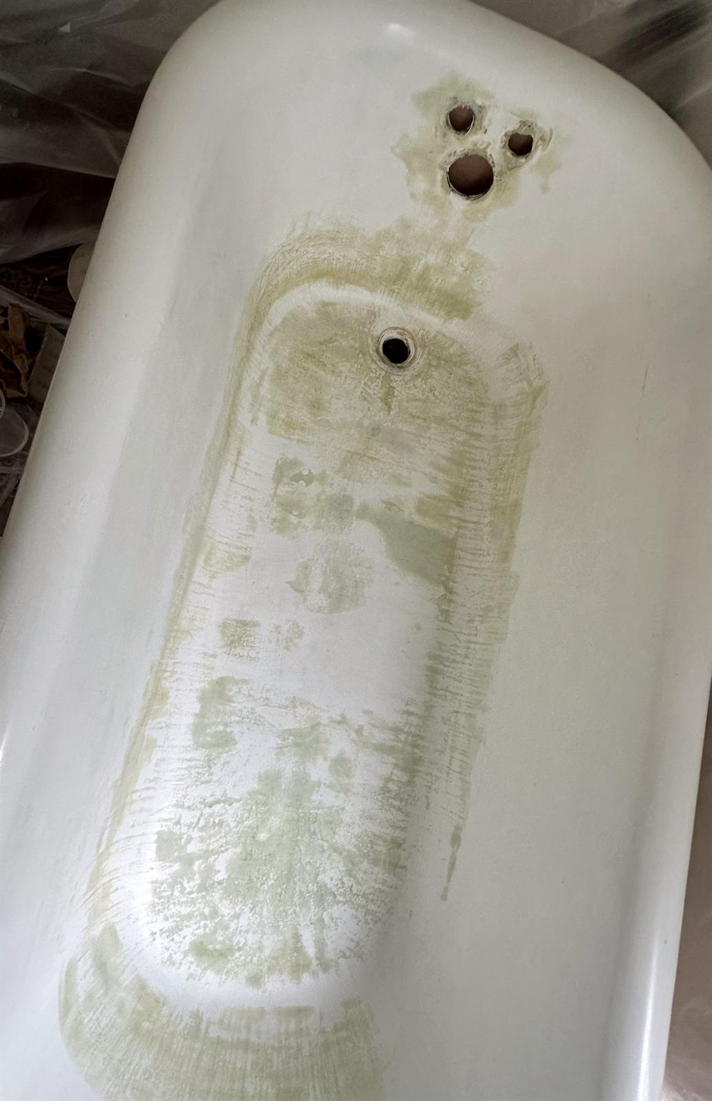 Before clawfoot tub resurfacing showing stripped coating and prep marks