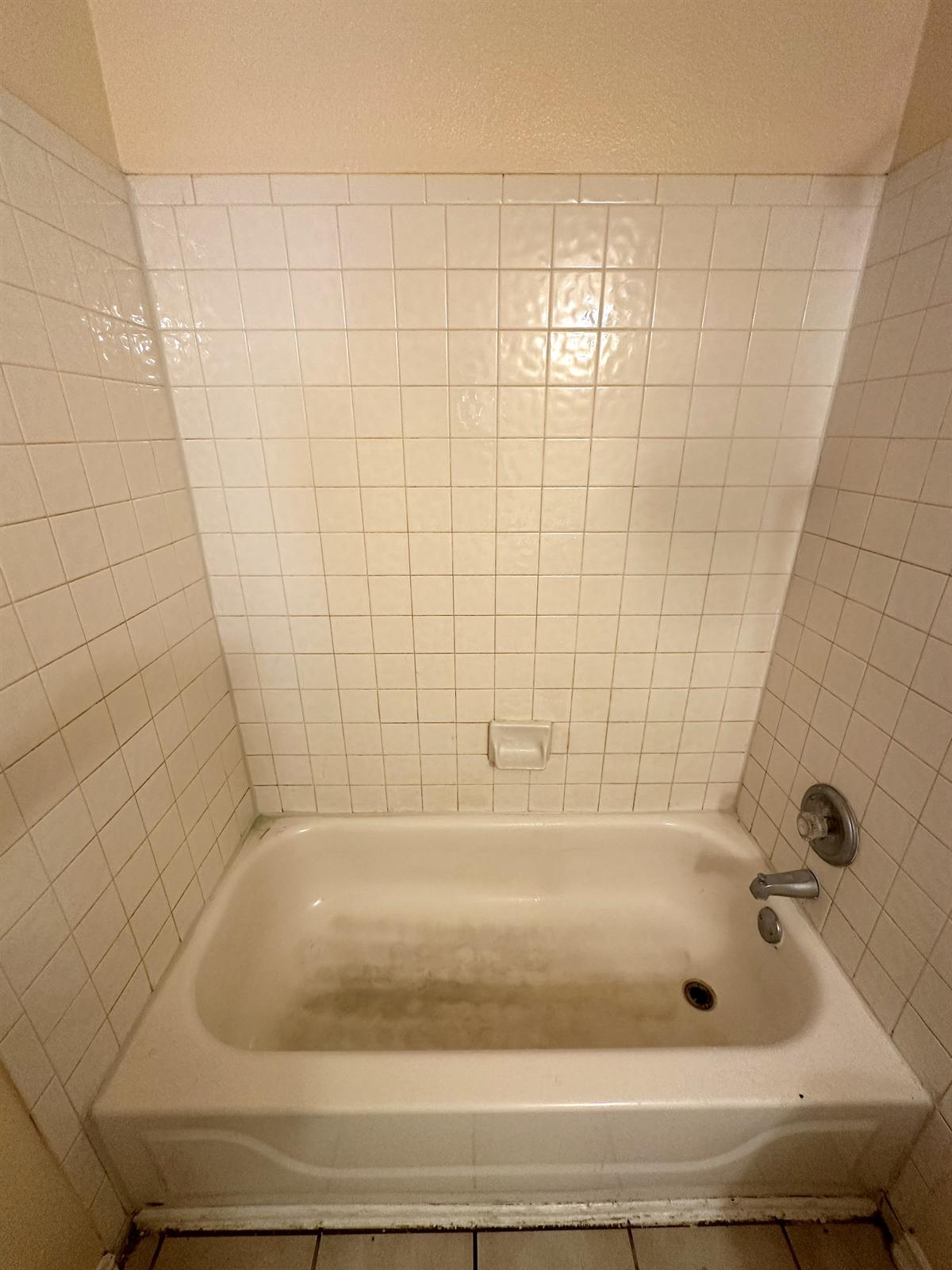 Before bathtub and tile refinishing with wall and tub discoloration