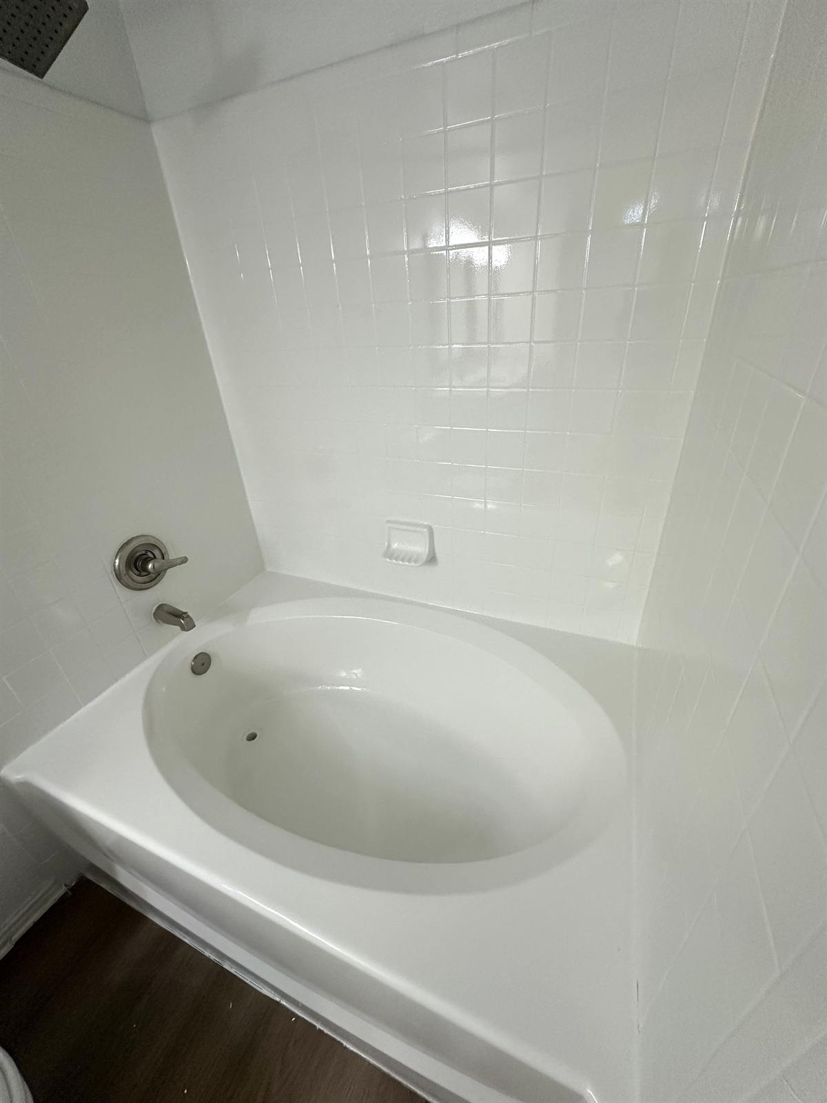 After one-day shower pan refinishing with bright uniform finish