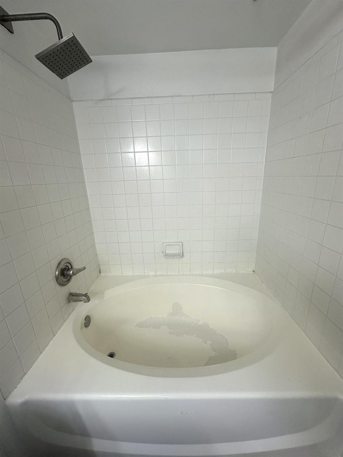 Before shower floor resurfacing with worn pan and damaged coating